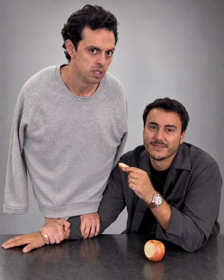 Escena de El Pájaro con dos hombres junto a una mesa y una manzana